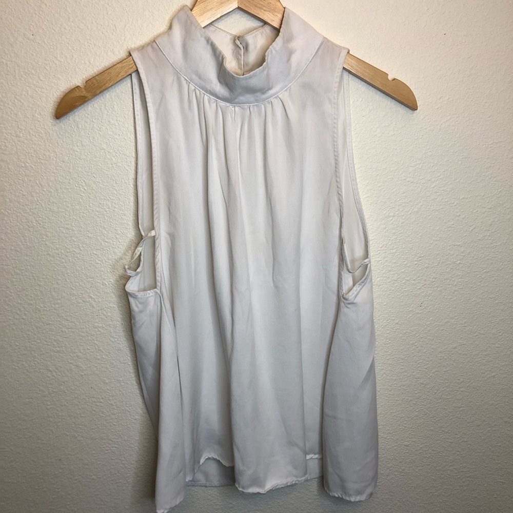 Free People Small White Top. High neck, 3 buttons, opening in back, sleeveless